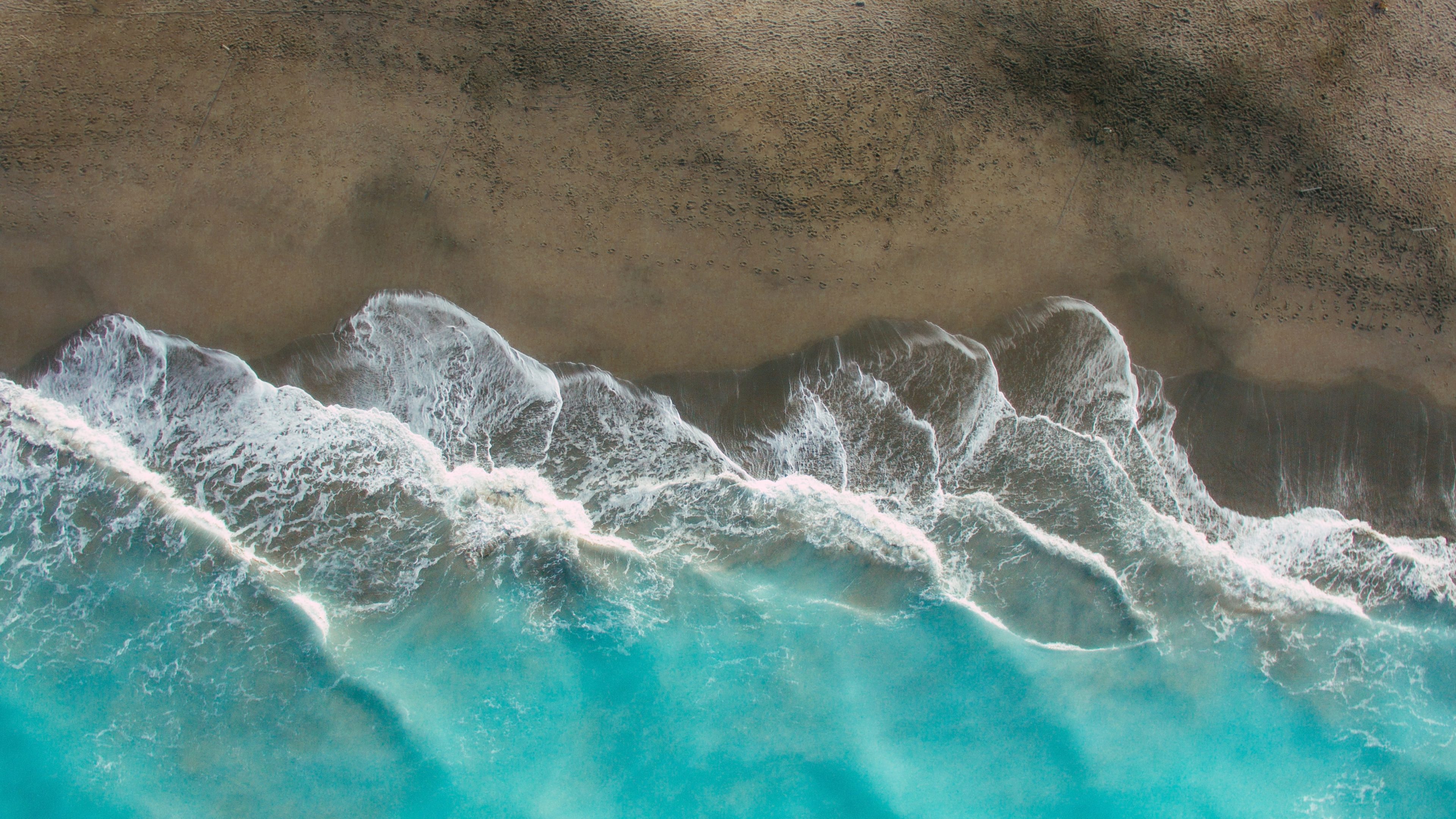 ocean waves crashing on shore during daytime