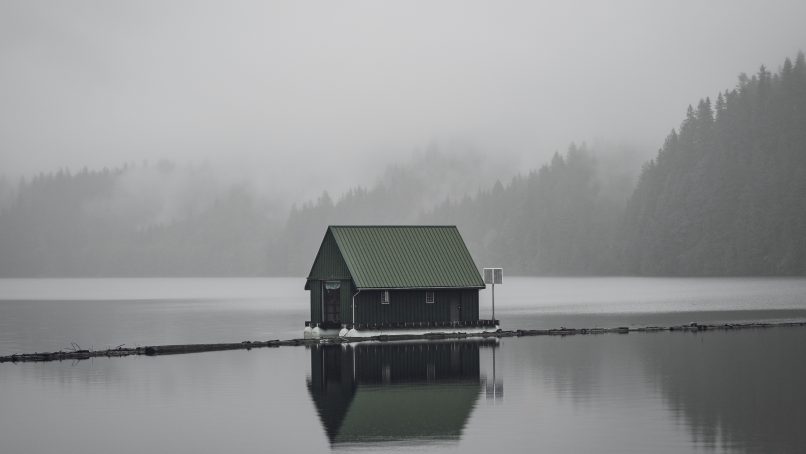 gray wooden house on body of water