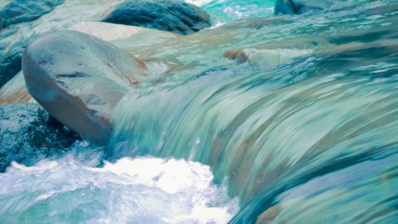 clear blue running water at daytime