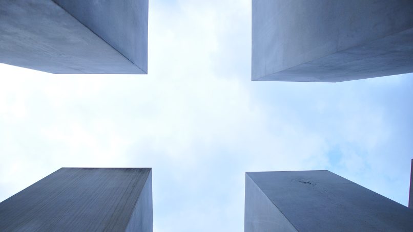 worm's eye view of four stone structures during daytime