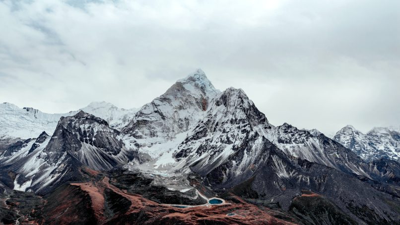 snow covered mountain under cloudy sky during daytime