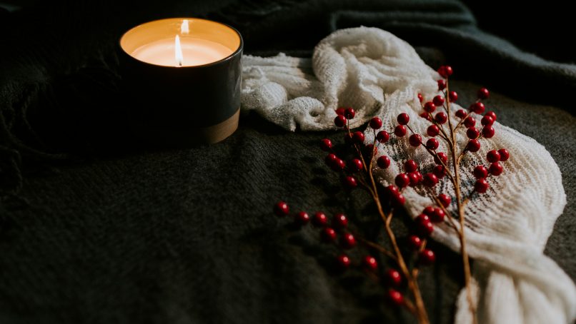 white candle on black holder