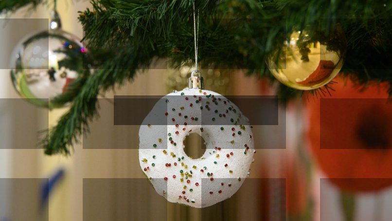 A donut ornament hangs on a christmas tree. — Samsung Frame TV art