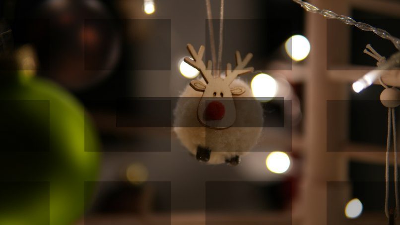A cute reindeer ornament hangs on a christmas tree. — Samsung Frame TV art