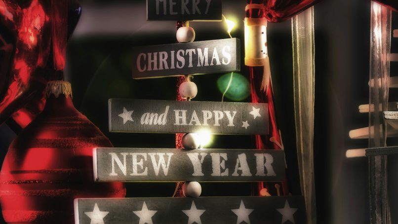 black and gray wooden signage near black wall