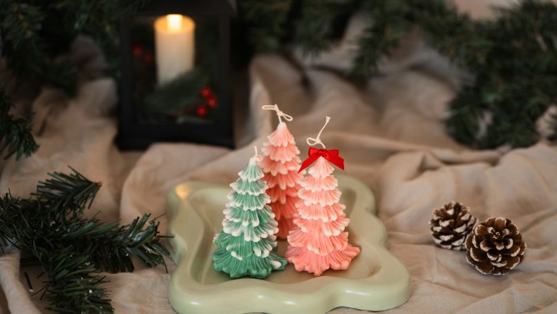 A couple of small christmas trees sitting on top of a table