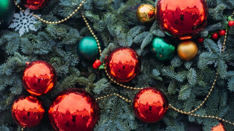 a bunch of red and green ornaments on a christmas tree