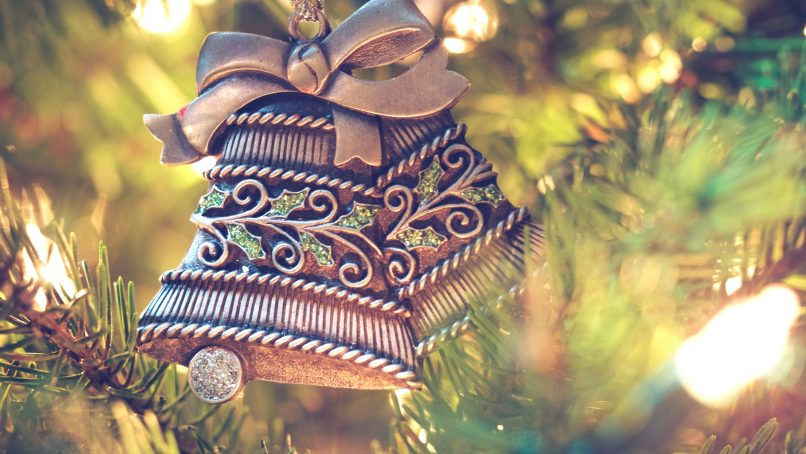 brown bell hanging on christmas tree