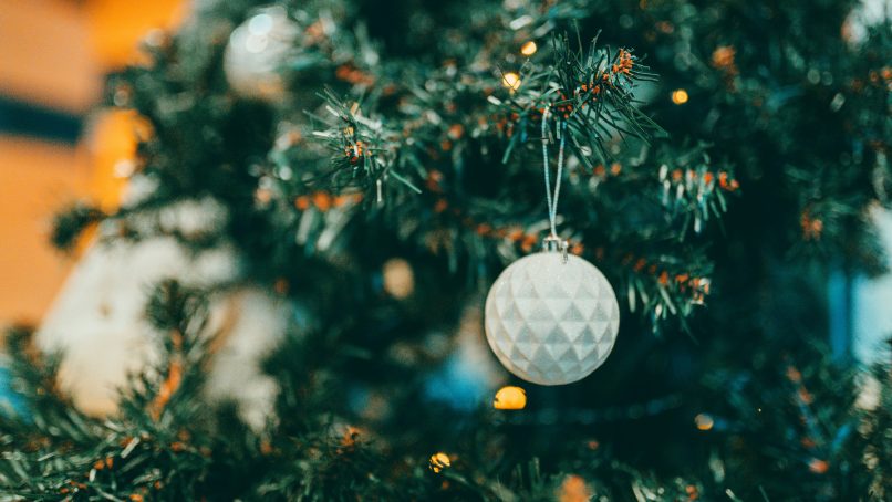 white and silver bauble on green christmas tree