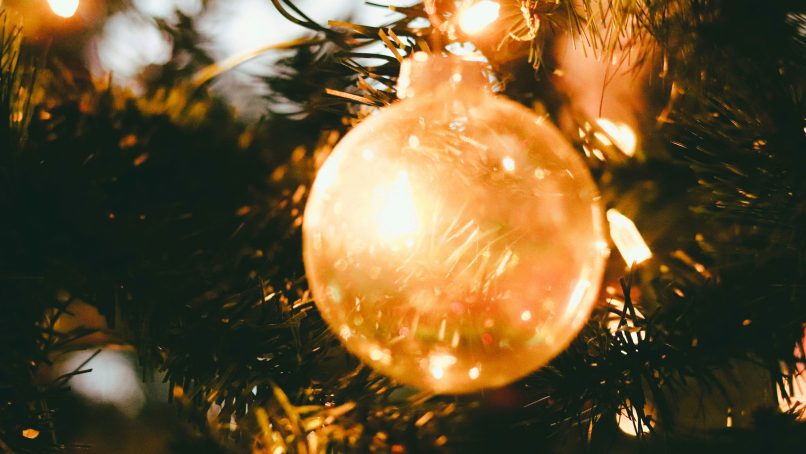gold baubles on green christmas tree
