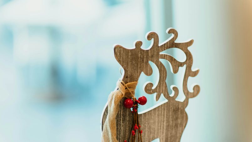 brown wooden carved reindeer decoration on table