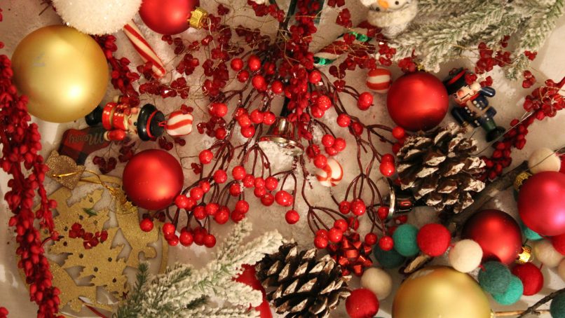 red and yellow baubles on green pine tree