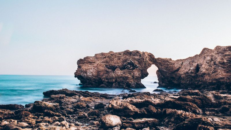 Rock arch formation along a tranquil sea — Samsung Frame TV art