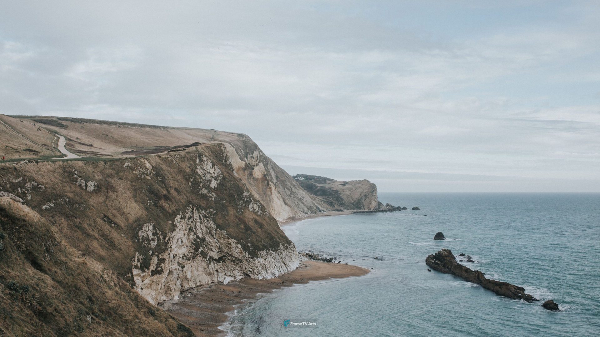 Coastal cliffside overlooking ocean with winding road in foreground — Samsung Frame TV art