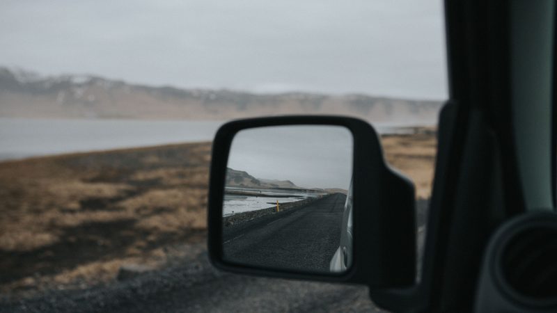 Road through barren landscape reflected in side view car mirror. — Samsung Frame TV art