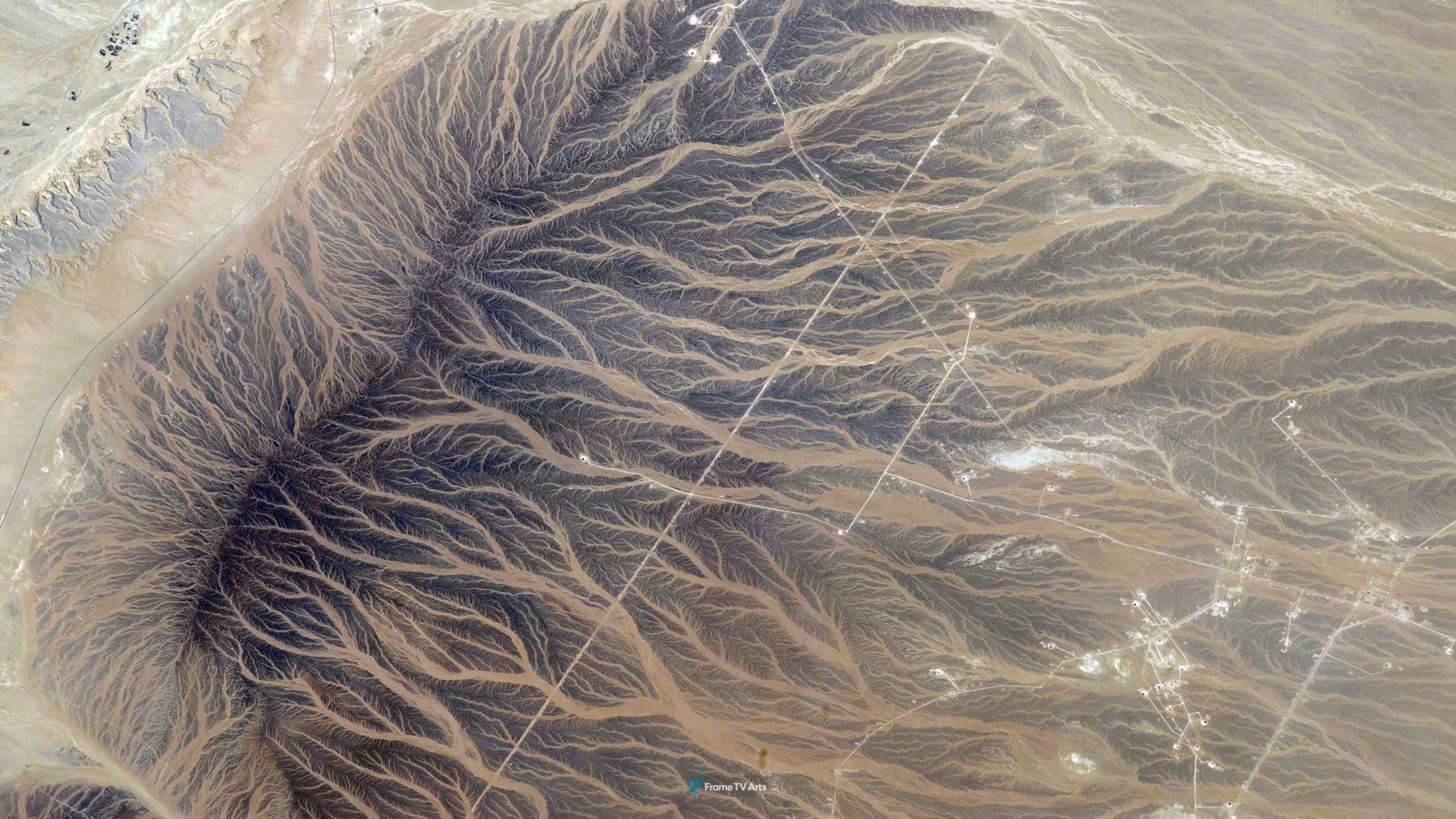 Aerial perspective of desert terrain with intricate patterns of erosion. — Samsung Frame TV art