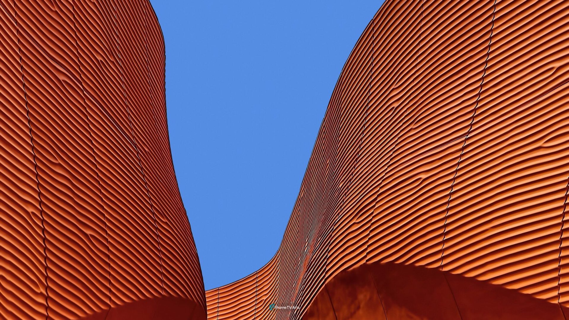 Abstract rust-colored modern building against blue sky. — Samsung Frame TV art