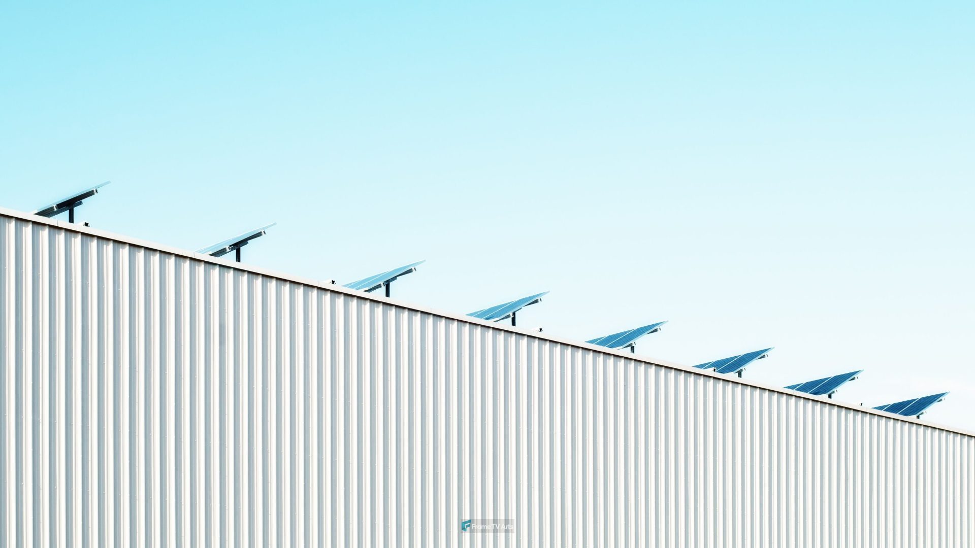 Solar panels line the edge of a corrugated building roof — Samsung Frame TV art