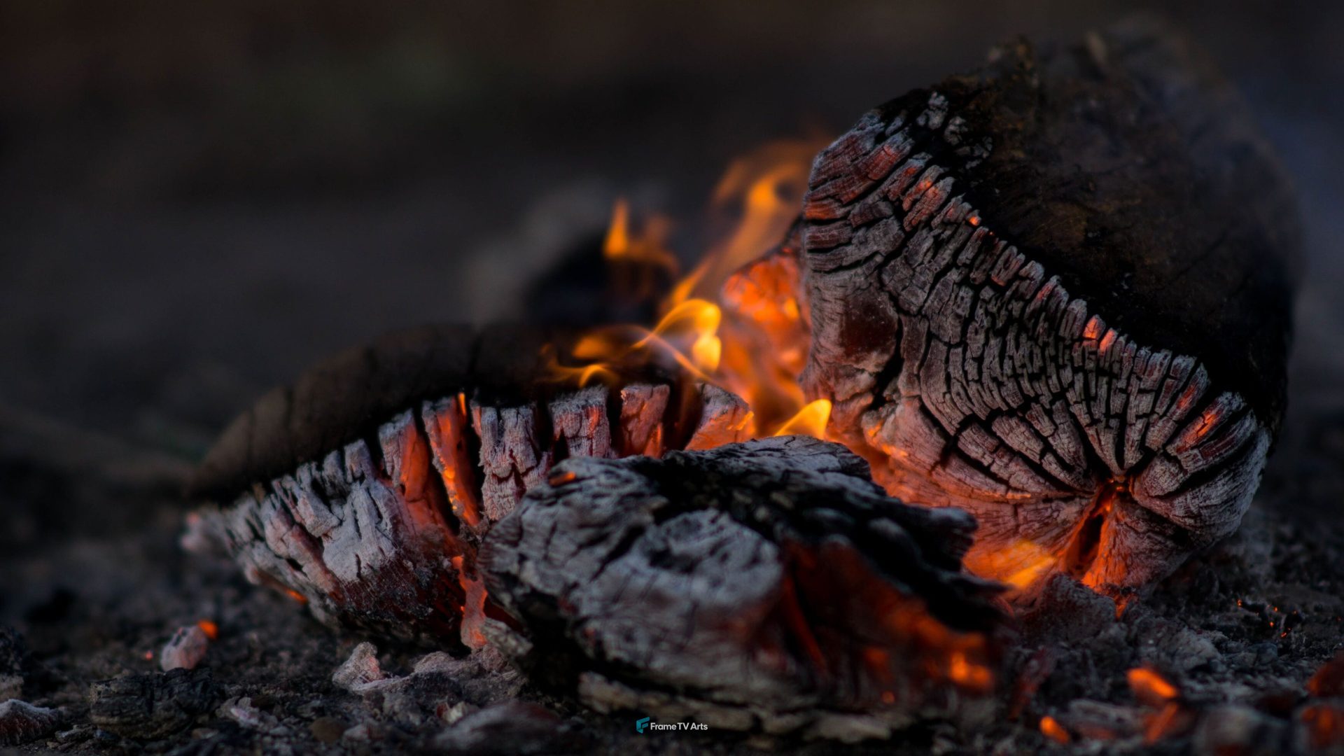 Close-up of glowing embers in a campfire at night. — Samsung Frame TV art