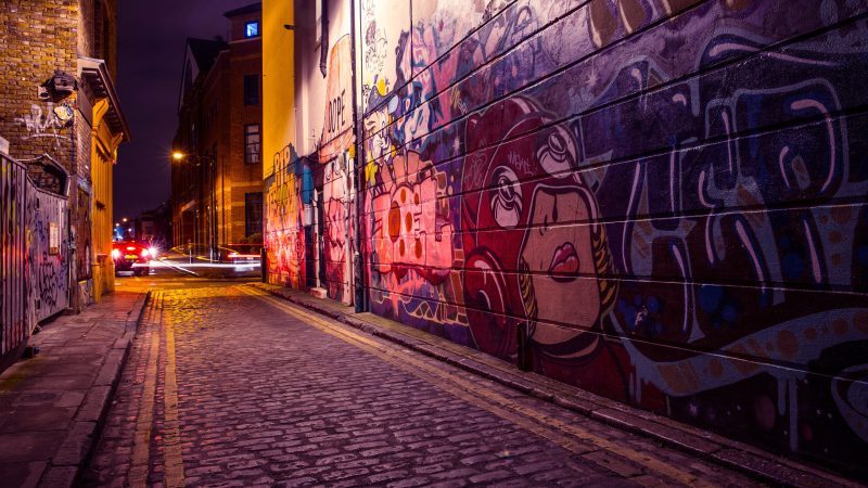 A brick road with graffiti on the side of a building — Samsung Frame TV art