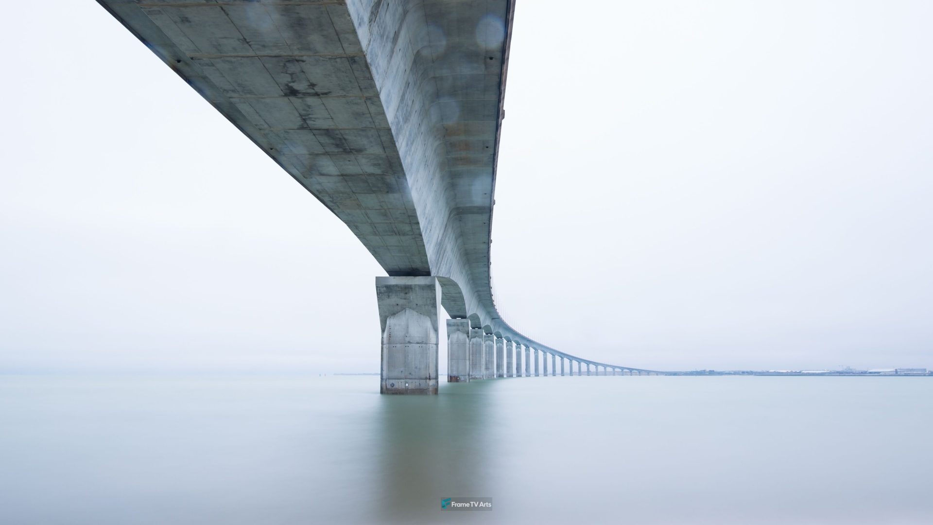 Long bridge crossing over calm waters with distant horizon — Samsung Frame TV art
