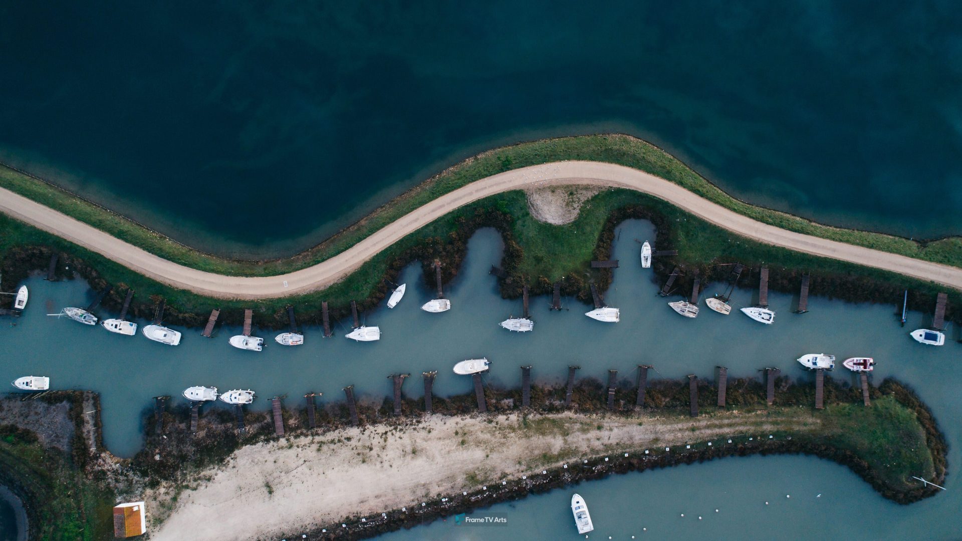 Aerial view of boats docked in a curving waterway. — Samsung Frame TV art
