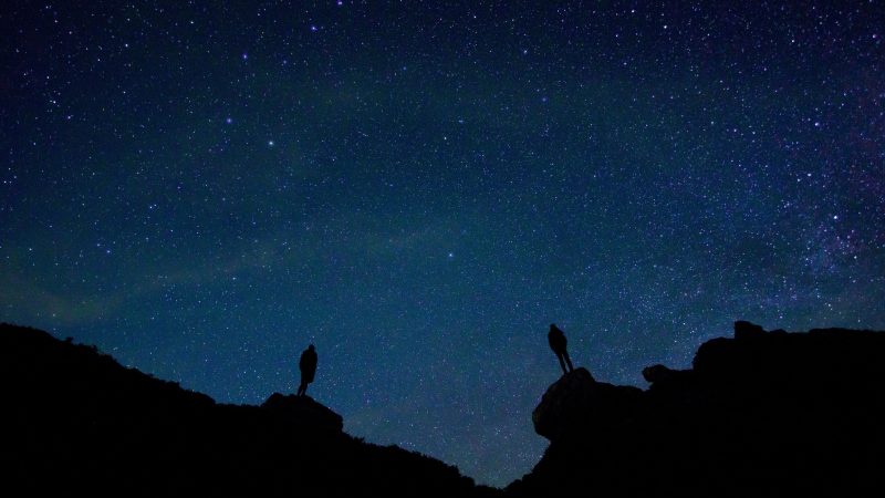 Silhouettes of two figures on rock against starry sky — Samsung Frame TV art