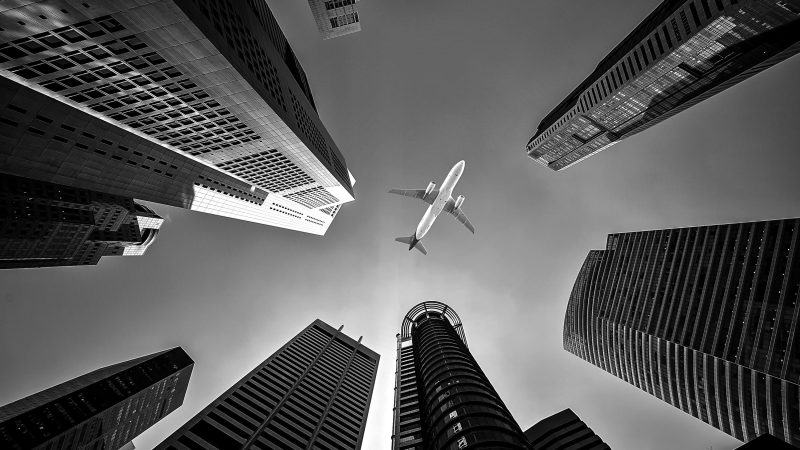 Plane Flying Through Sky Between Tall Buildings — Samsung Frame TV art