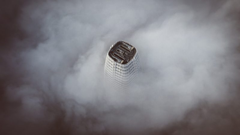 white concrete building surrounded by clouds — Samsung Frame TV art