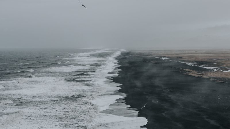 Black sand beach with crashing waves and misty horizon view — Samsung Frame TV art