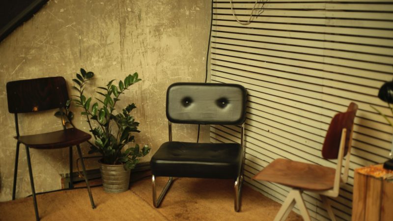 two brown and black chairs on brown wood flooring — Samsung Frame TV art