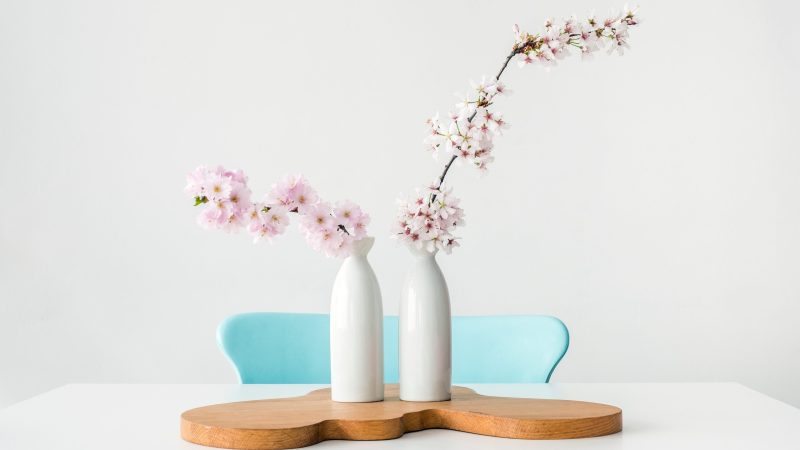 two pink petaled flowers in white vases on brown wooden surface — Samsung Frame TV art